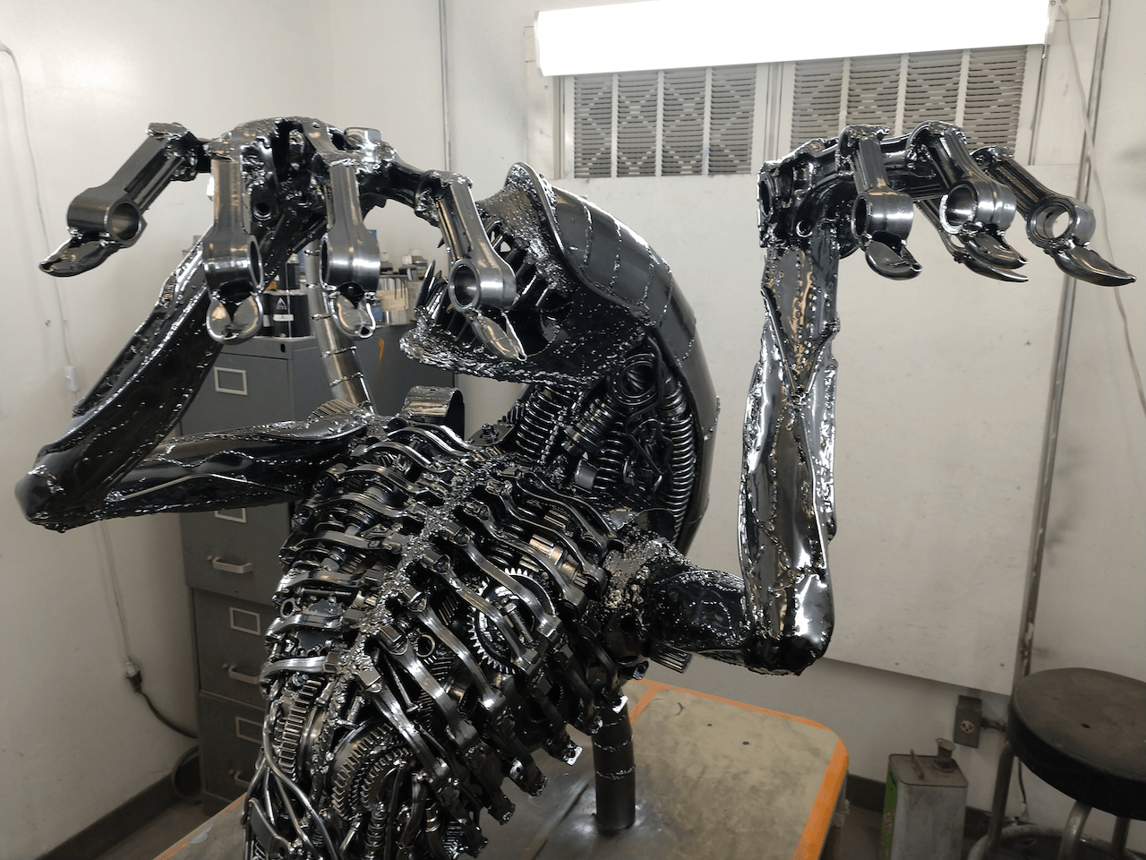 A statue of an alien is sitting on a table in a room