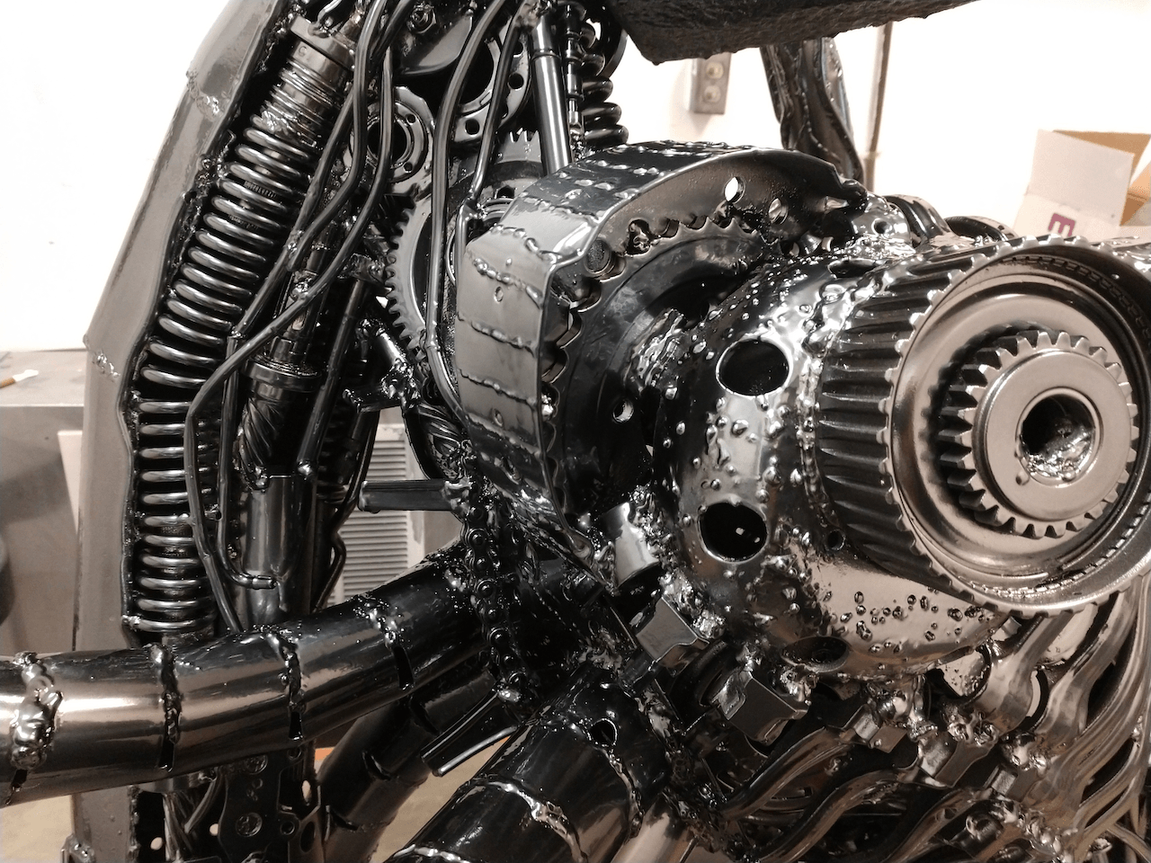 A close up of a metal sculpture of an alien