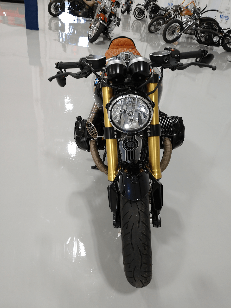 A motorcycle is parked in a garage with other motorcycles