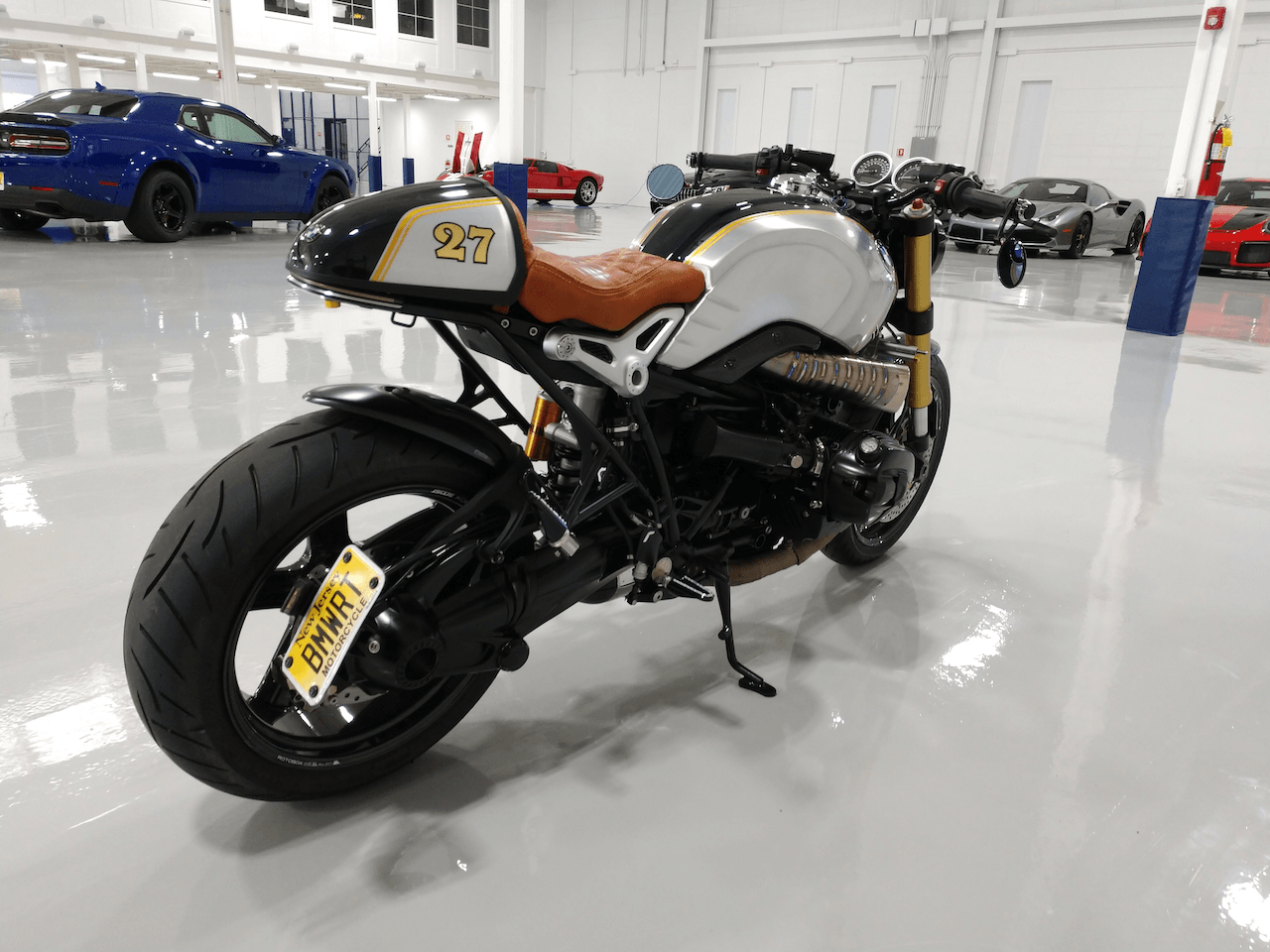 A motorcycle with a new york license plate is parked in a garage.