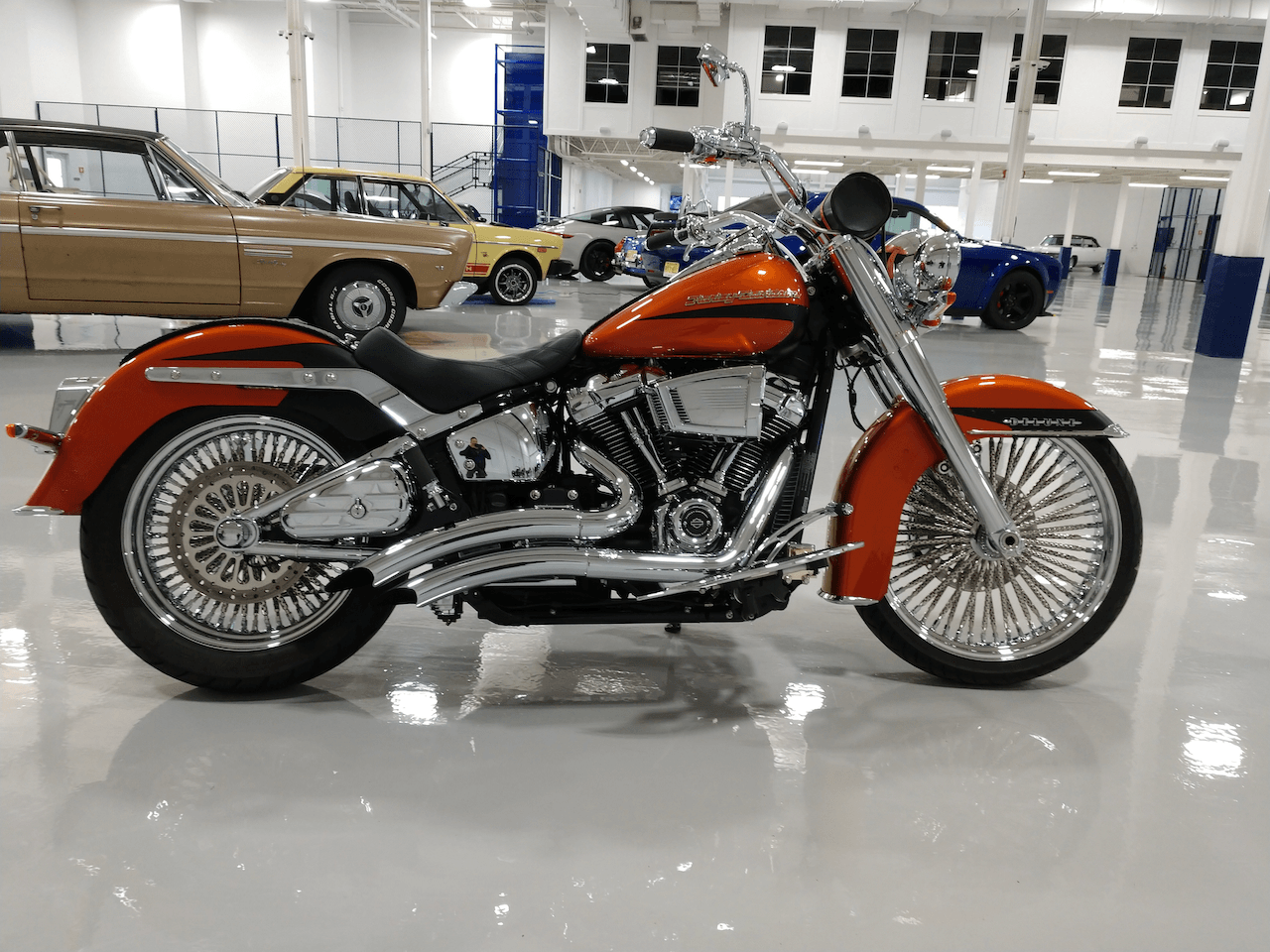 A red harley davidson motorcycle is parked in a garage.