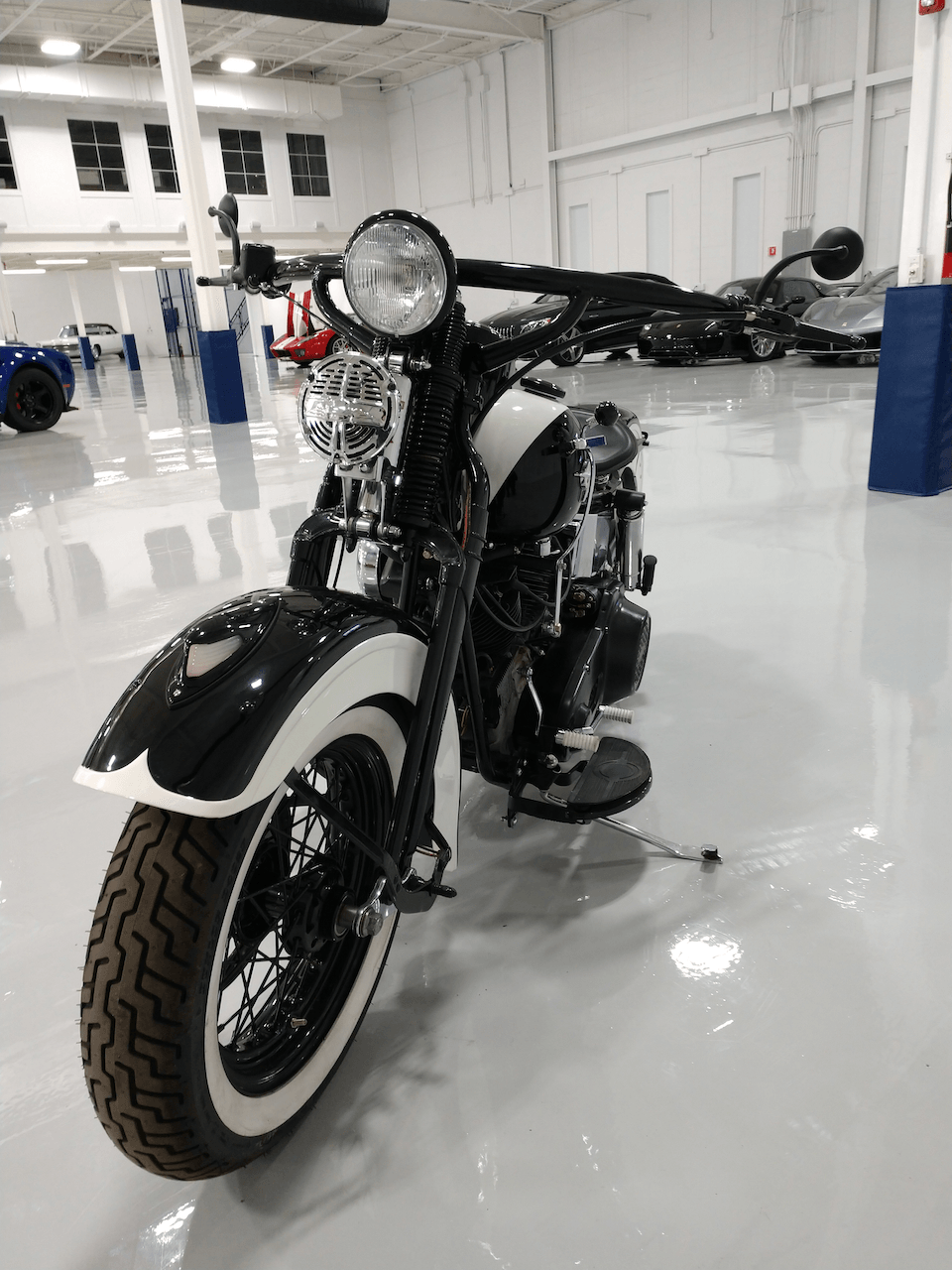 A black and white motorcycle is parked in a garage.