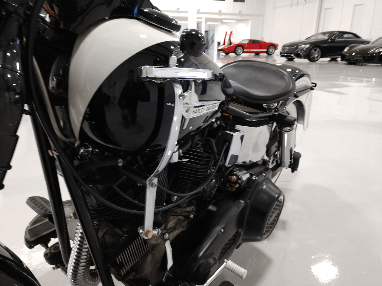 A black and white motorcycle is parked in a garage