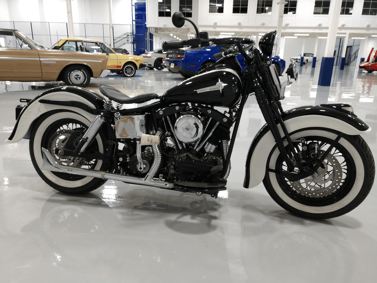 A black and white motorcycle is parked in a garage.