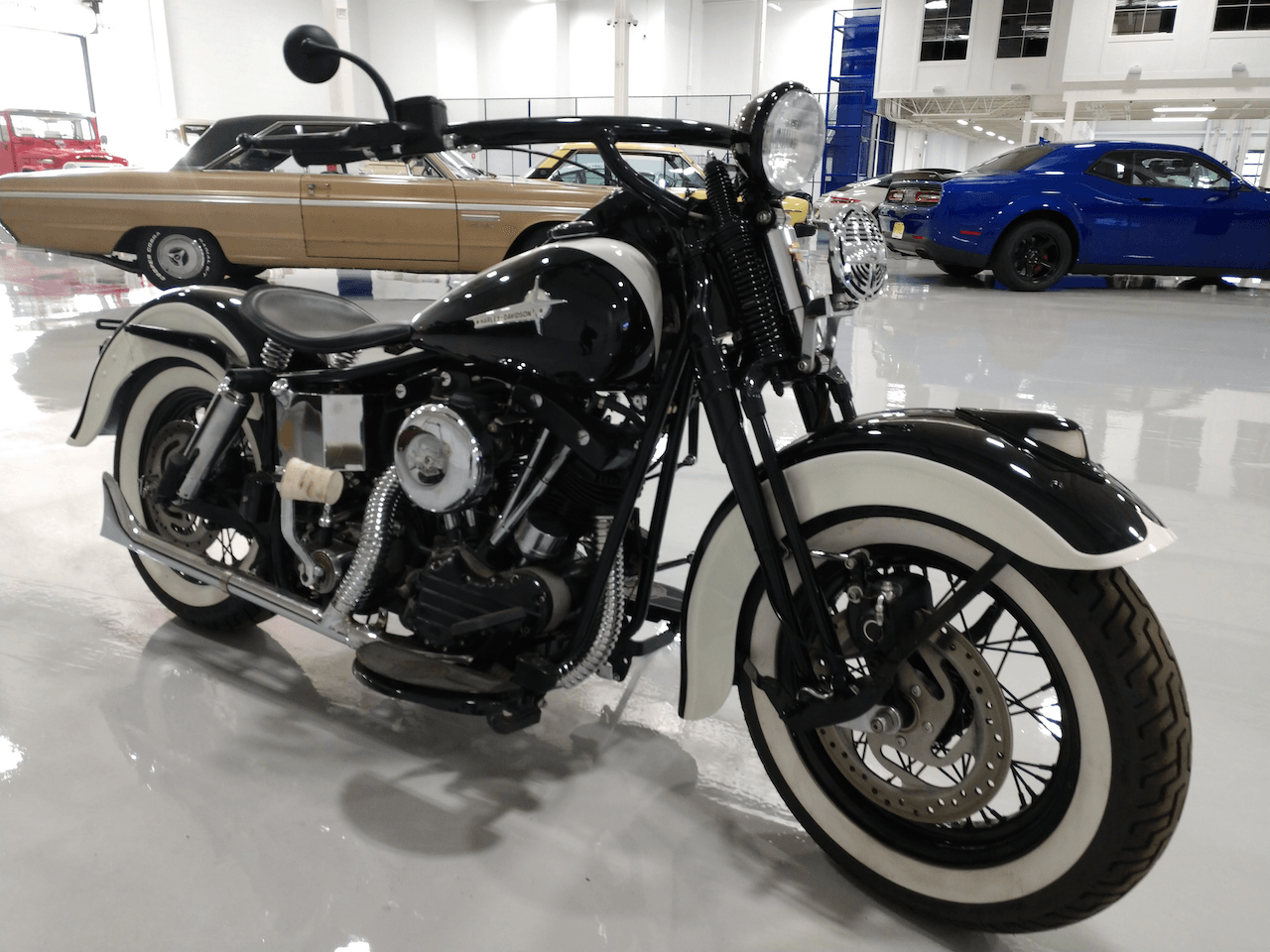 A black and white motorcycle is parked in a garage