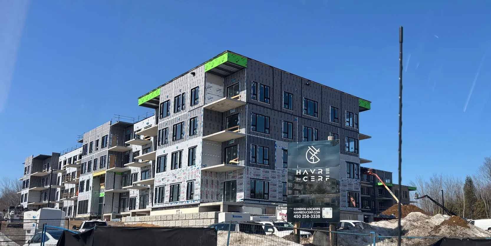 Immeuble d'appartements moderne en construction avec toitures végétalisées à un coin de rue enneigé