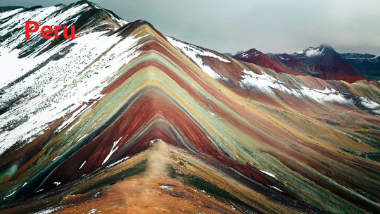 Colorful Rainbow Mountain Vinicunca near Cusco, Peru, with vibrant red, yellow, and green mountain slopes