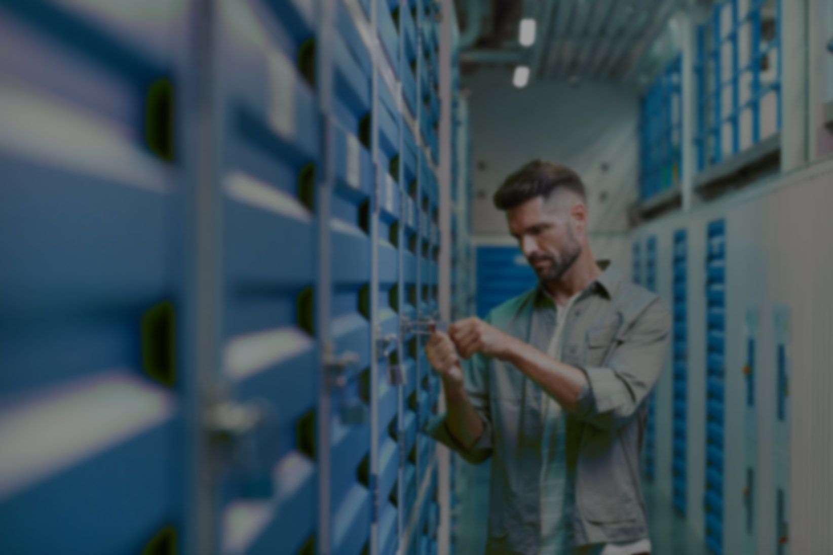A man is working on a server in a data center.