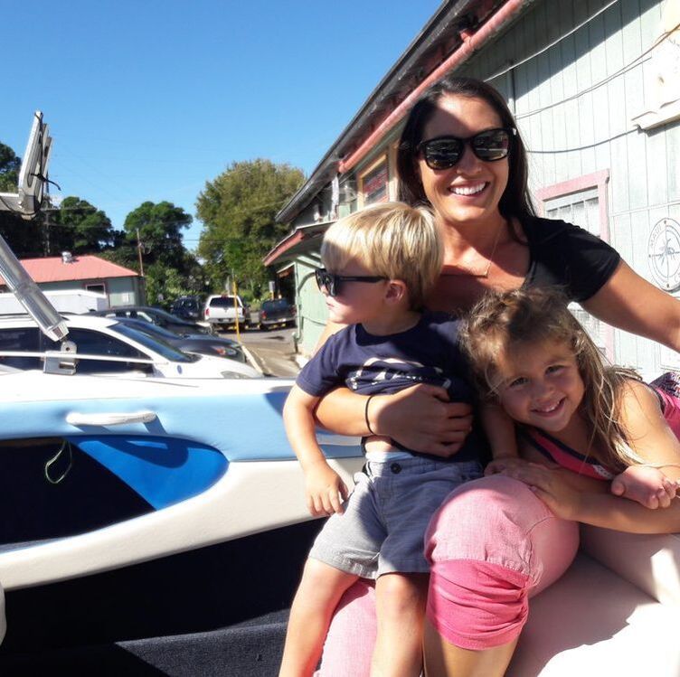 Mother and children sitting in a boat