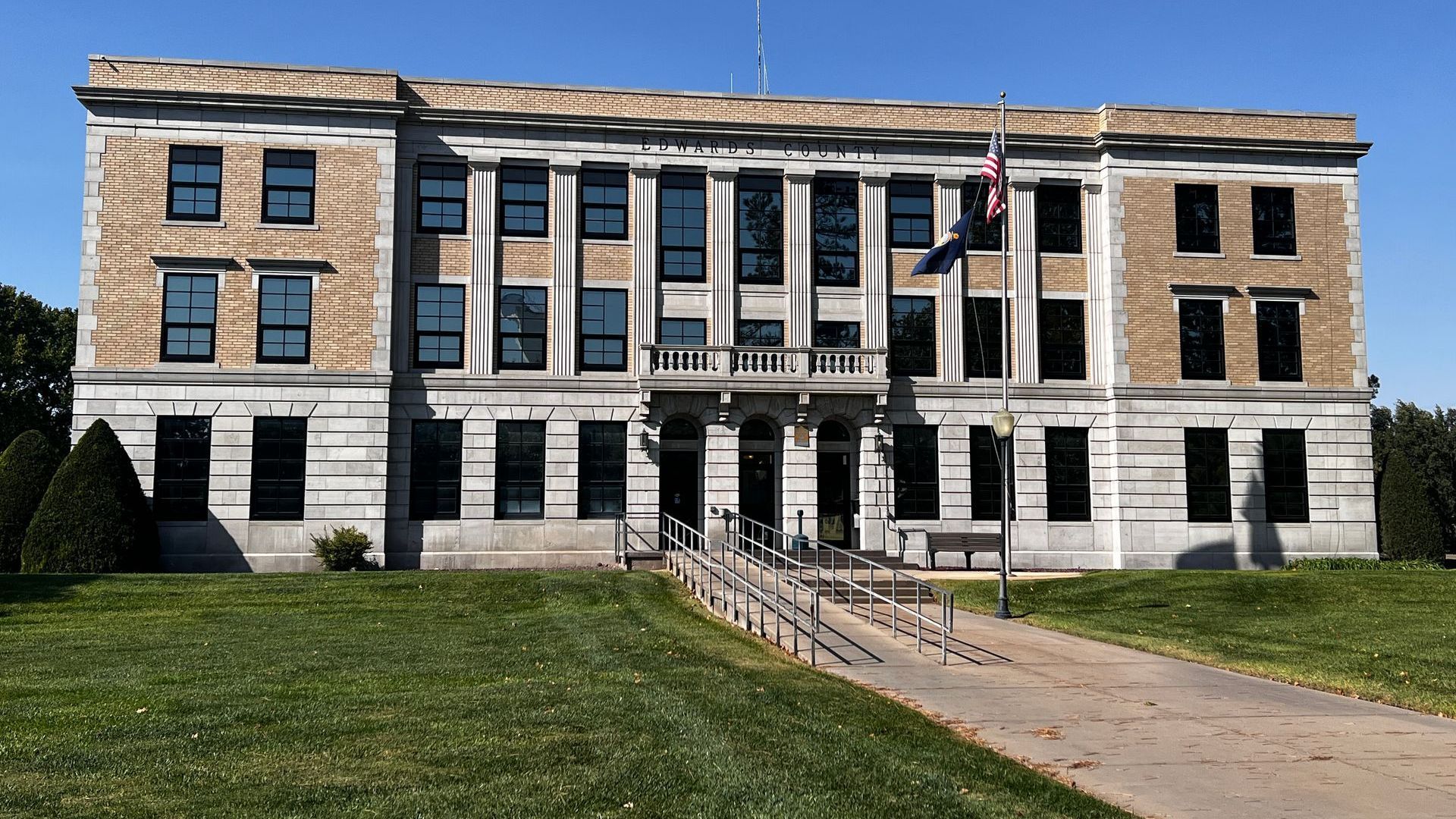 A large building with a flag in front of it