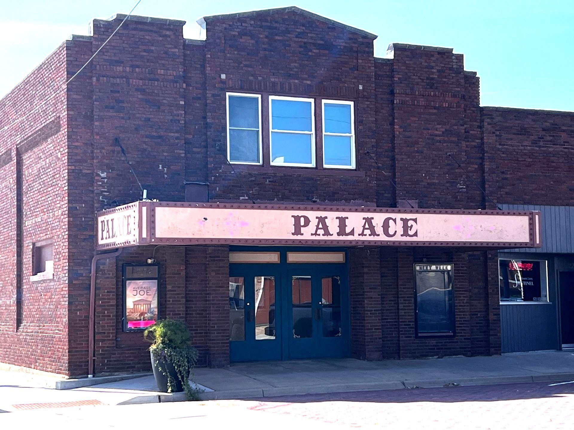 A brick building with a sign that says palace