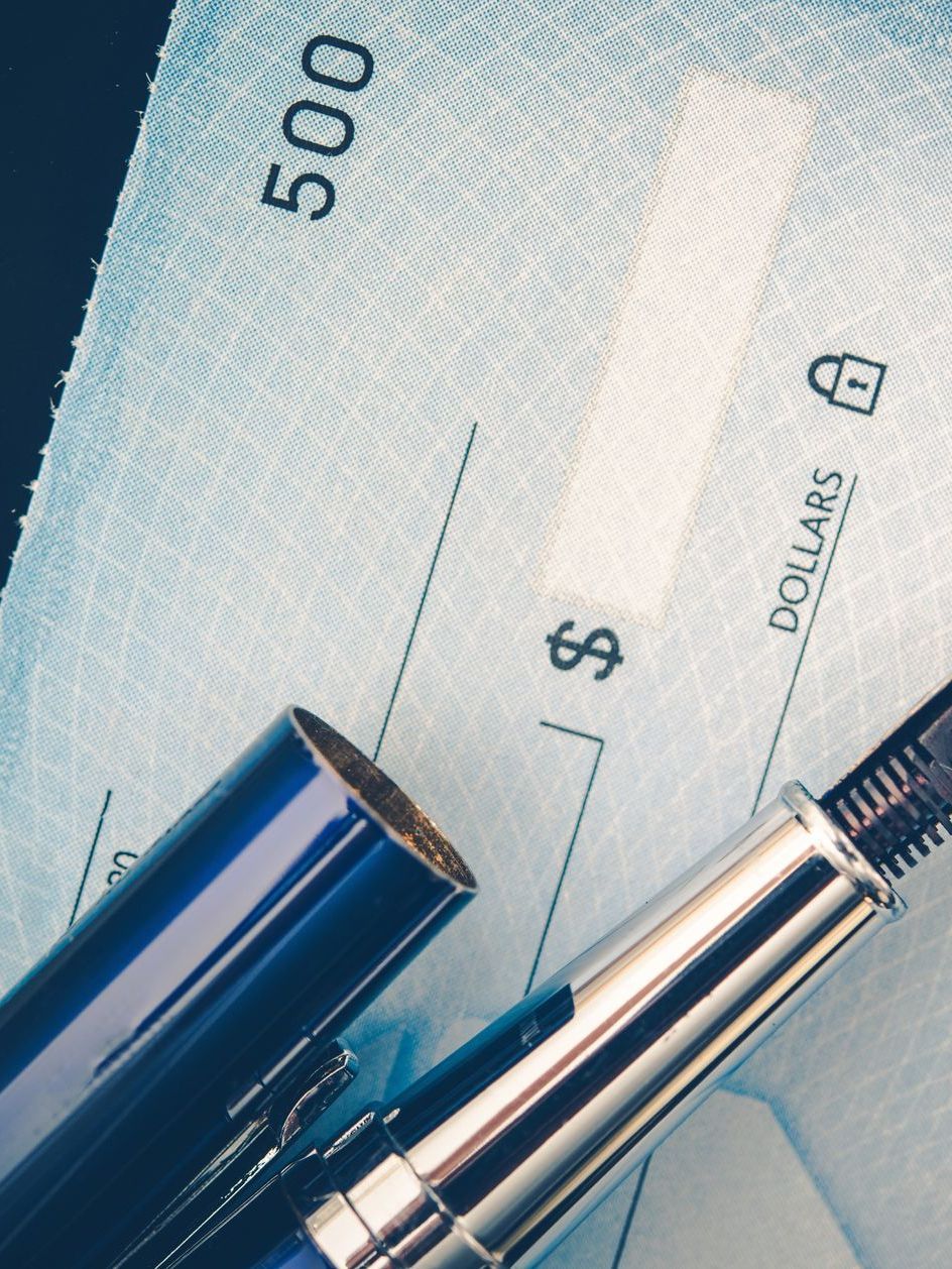 A pen is laying on top of a check