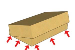 Closed cardboard box with red arrows pointing up from underneath