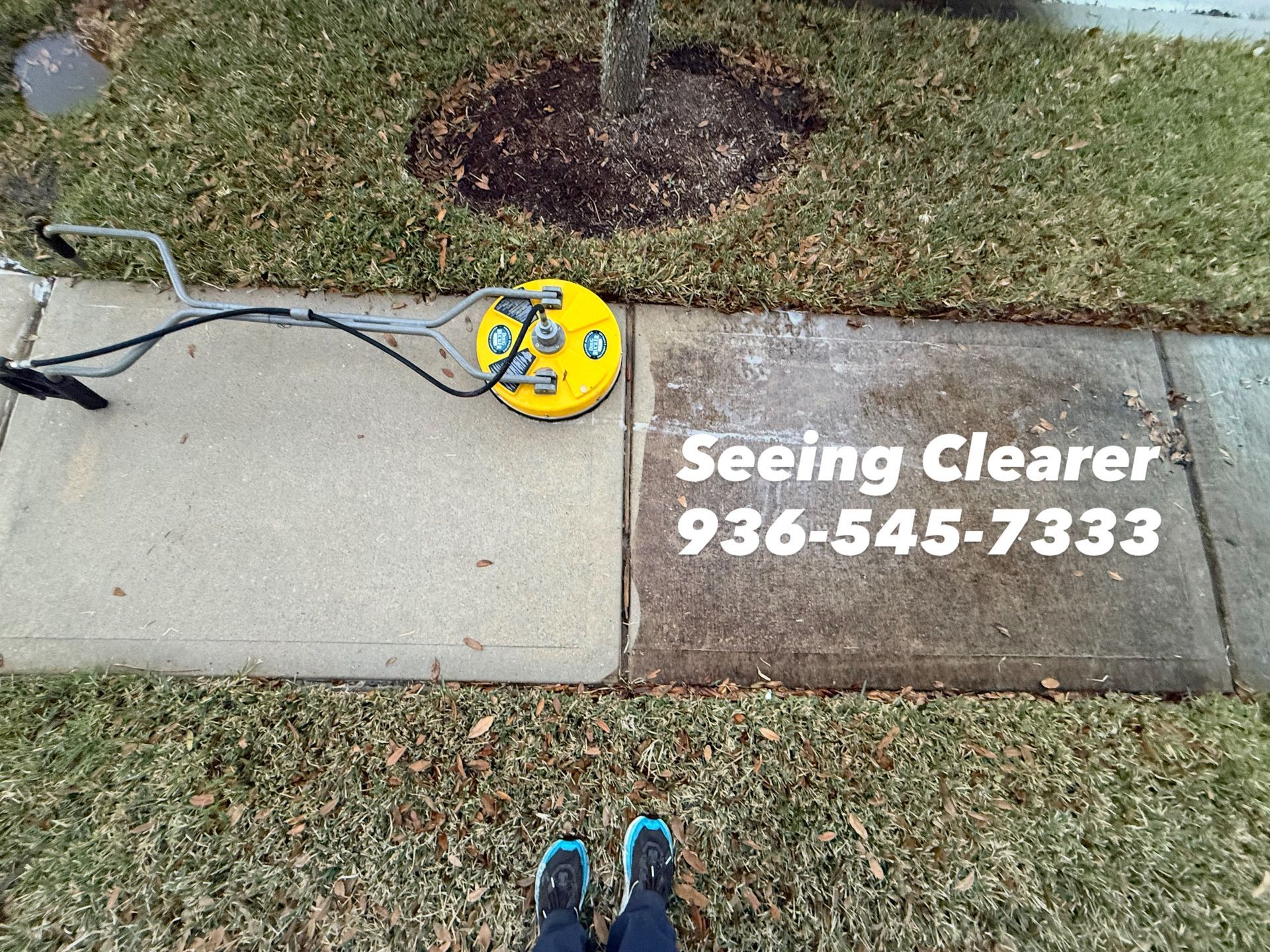 Lawn sign near sidewalk reads “Seeing Clearer 936-545-7333” with a yellow reel and hose nearby.