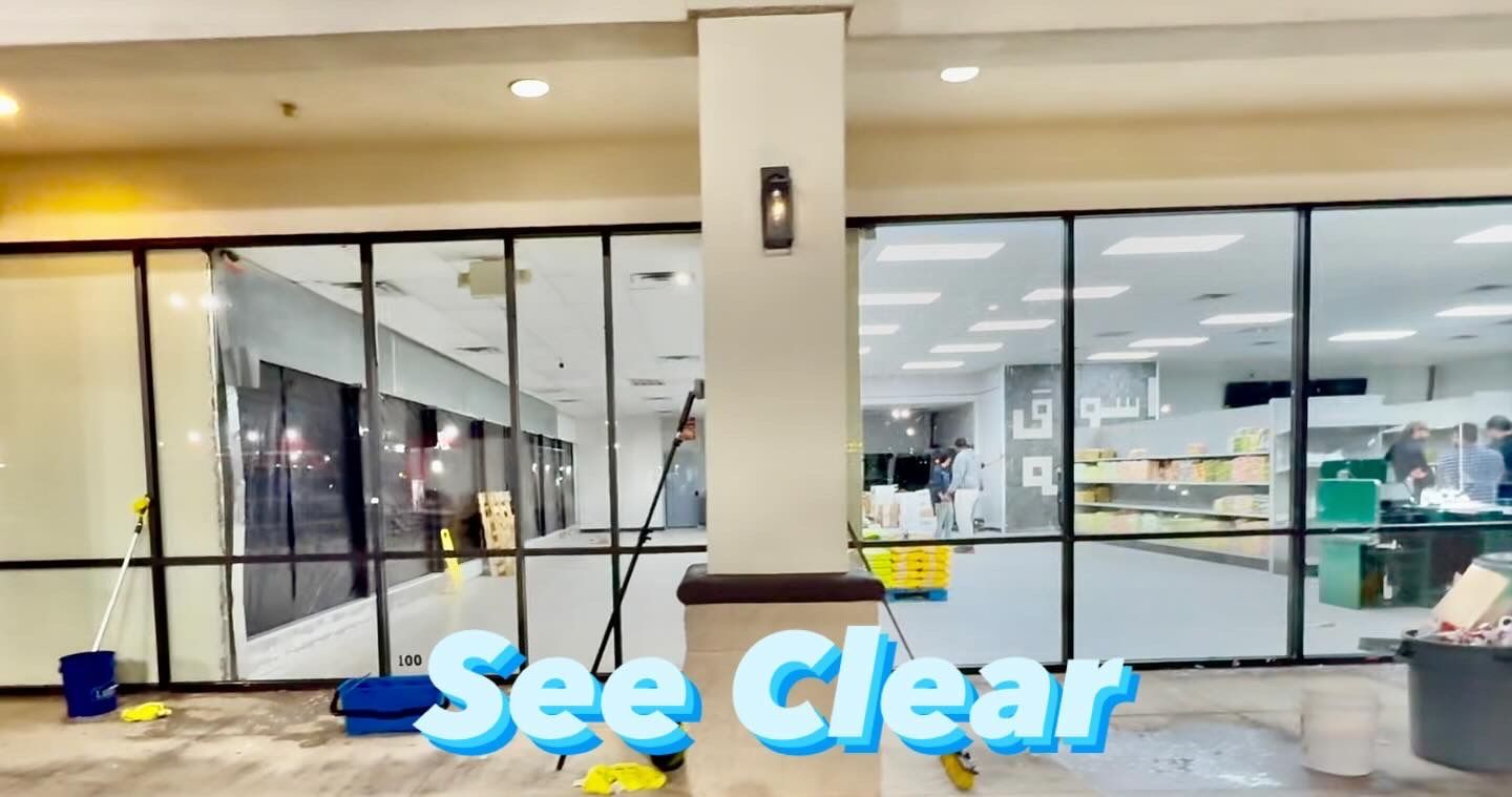 Storefront with glass doors and windows, and the words “See Clear” in bright blue at the bottom.