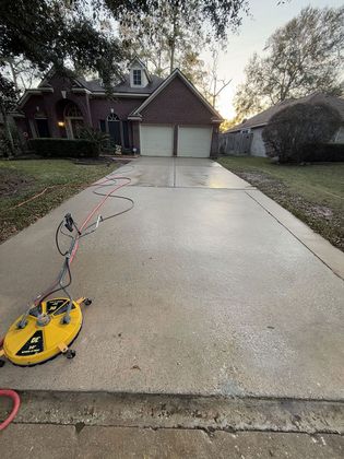 A before-and-after comparison of a dirty driveway being pressure washed, with the text 