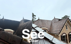 Roofs of houses under a blue sky with the words “See Clear” overlaid