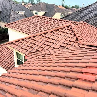 Red clay tile roofs on suburban houses viewed from above