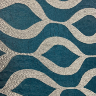 Abstract teal and beige wavy geometric fabric pattern
