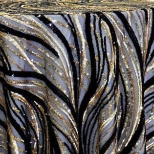 Black, gray, and gold zebra-striped fabric with shimmering metallic accents