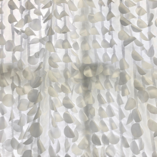 White translucent curtain with repeating leaf-like pattern and soft shadows