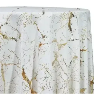 White marble-patterned tablecloth with gold veining draped over a round table