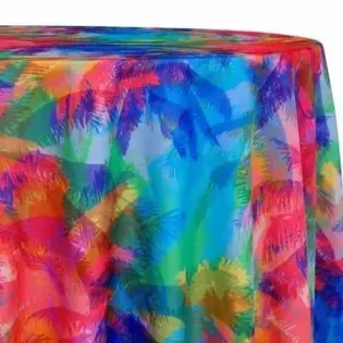Multicolored abstract tropical pattern with palm leaves draped over a table or fabric surface