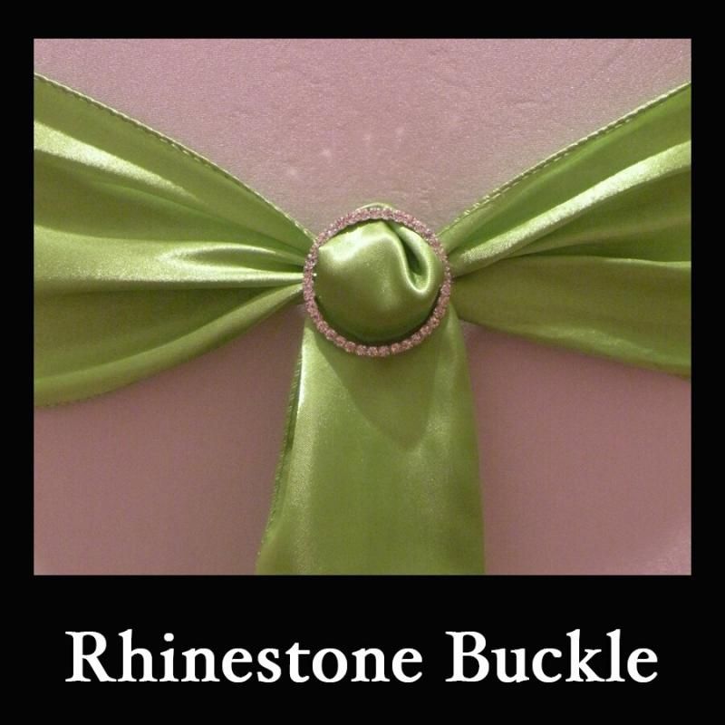 Green satin ribbon with a rhinestone buckle on a pink background