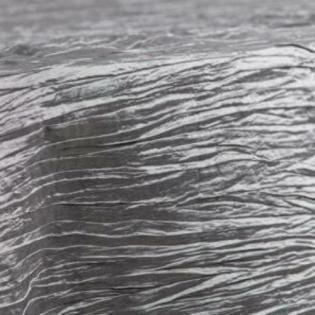 Close-up of rippling gray water with a dark shadow beneath the surface