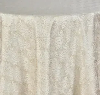 Close-up of a cream curtain with a subtle leaf pattern