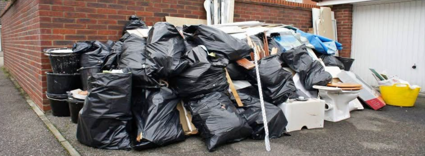 A bunch of junk in front of a client's house waiting to be removed by Junk Champions Junk Removal