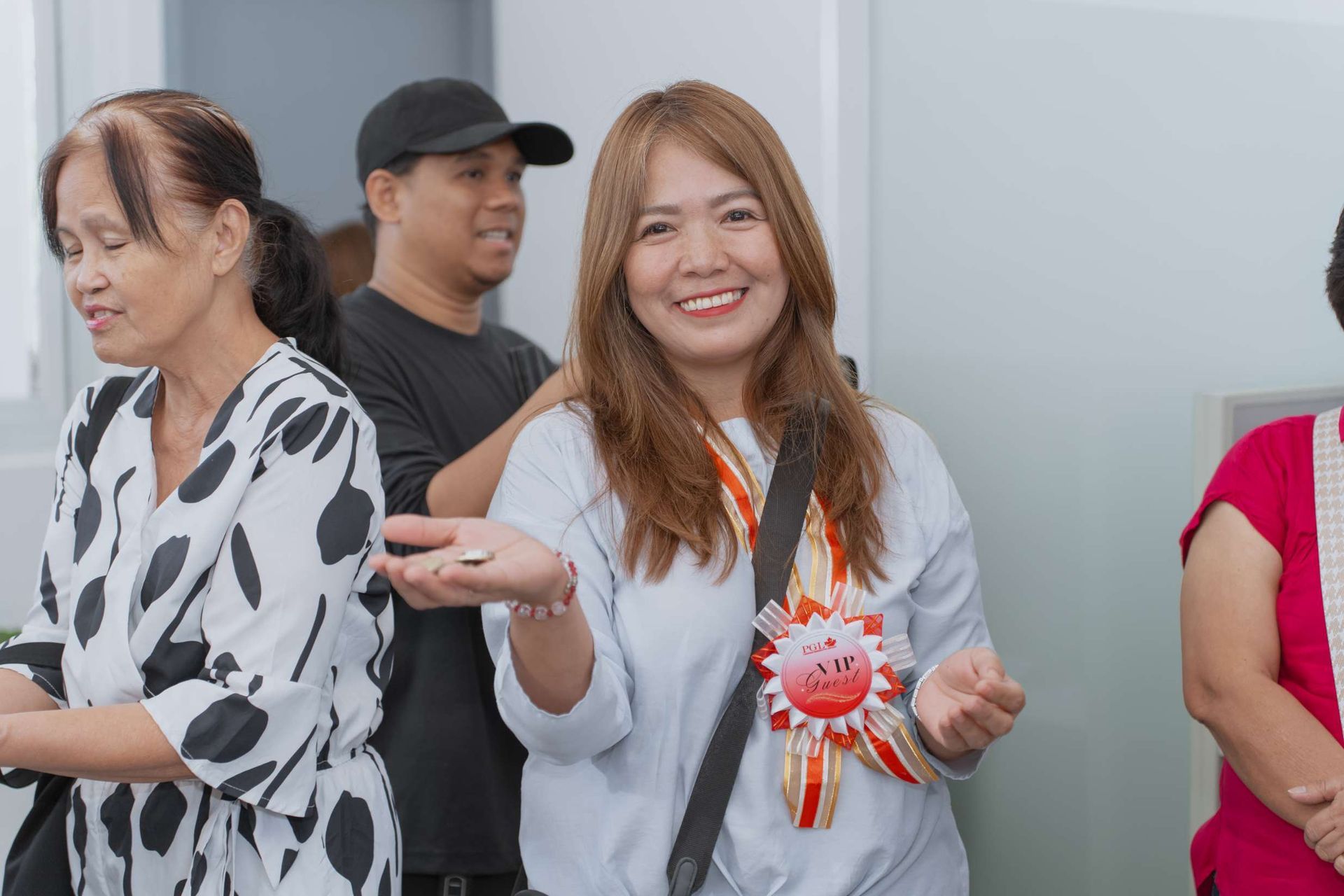 A group of people are standing next to each other in a room and smiling.