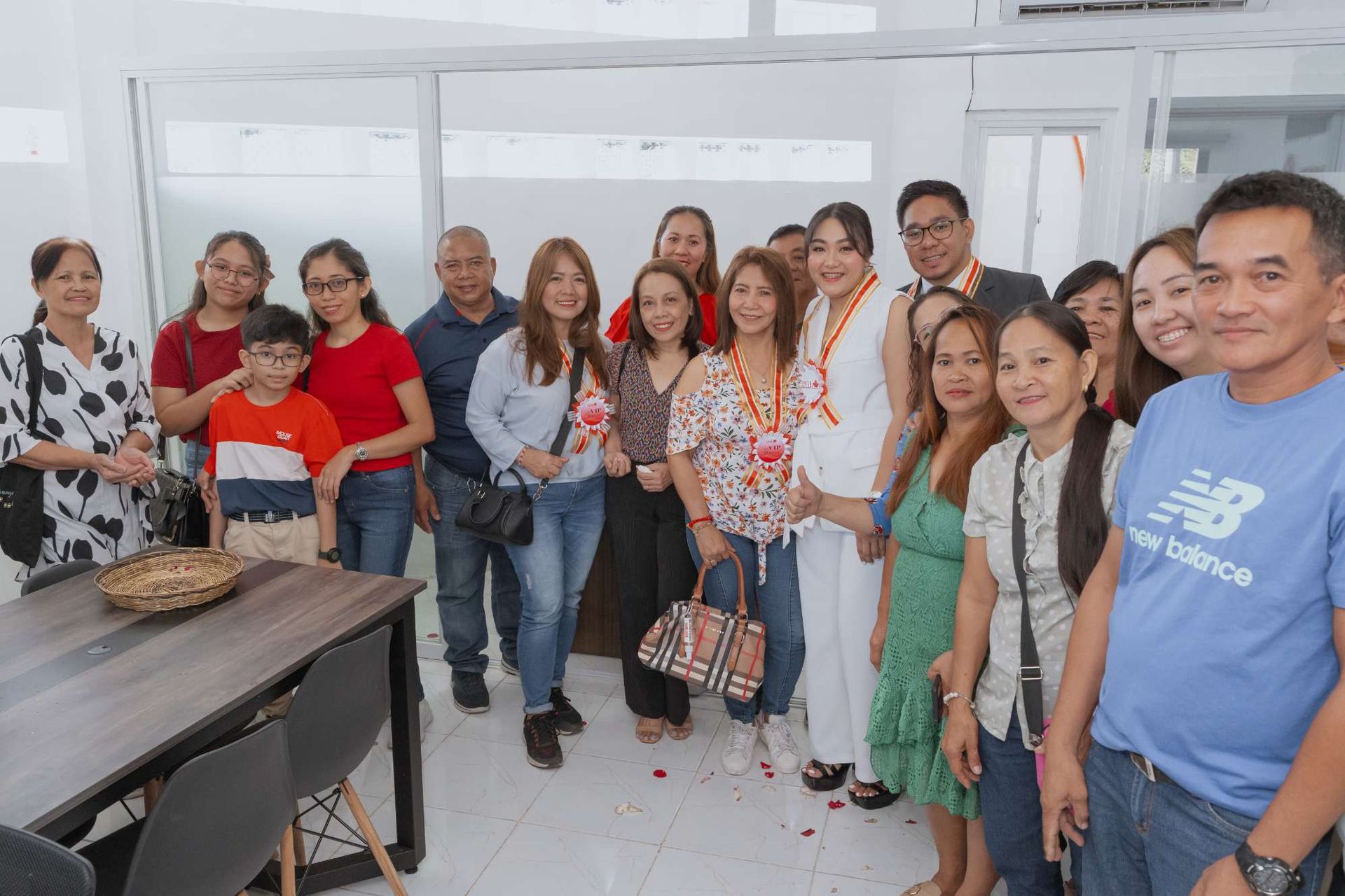 A large group of people are posing for a picture in a room.