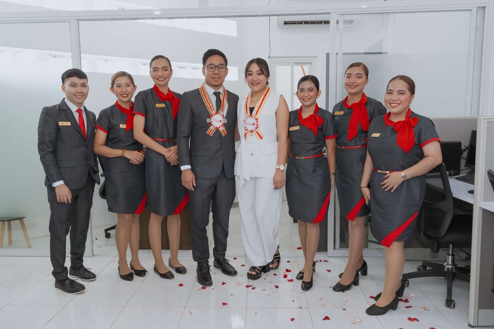 A group of people are posing for a picture in an office.