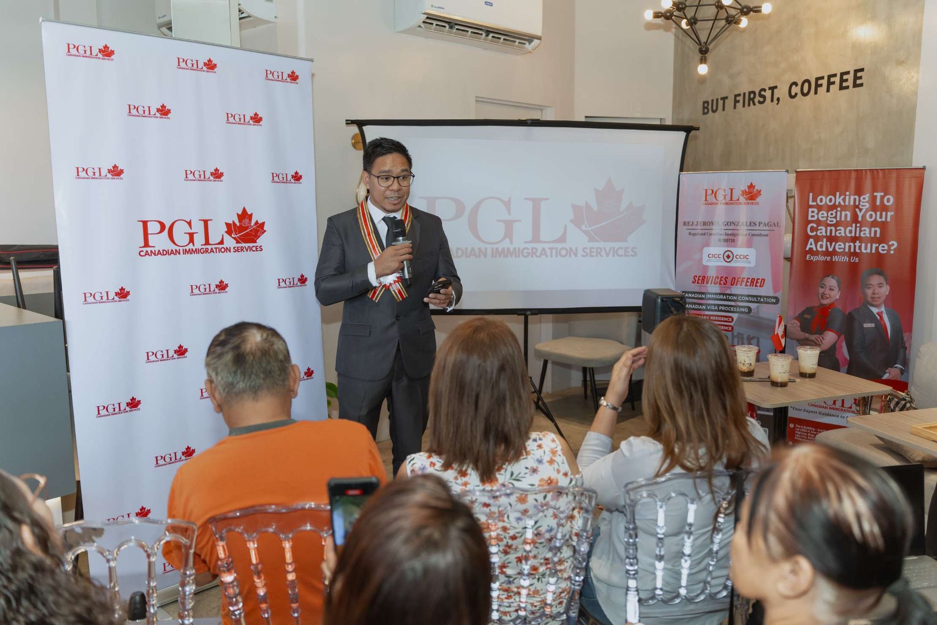 A man in a suit is giving a presentation to a group of people.