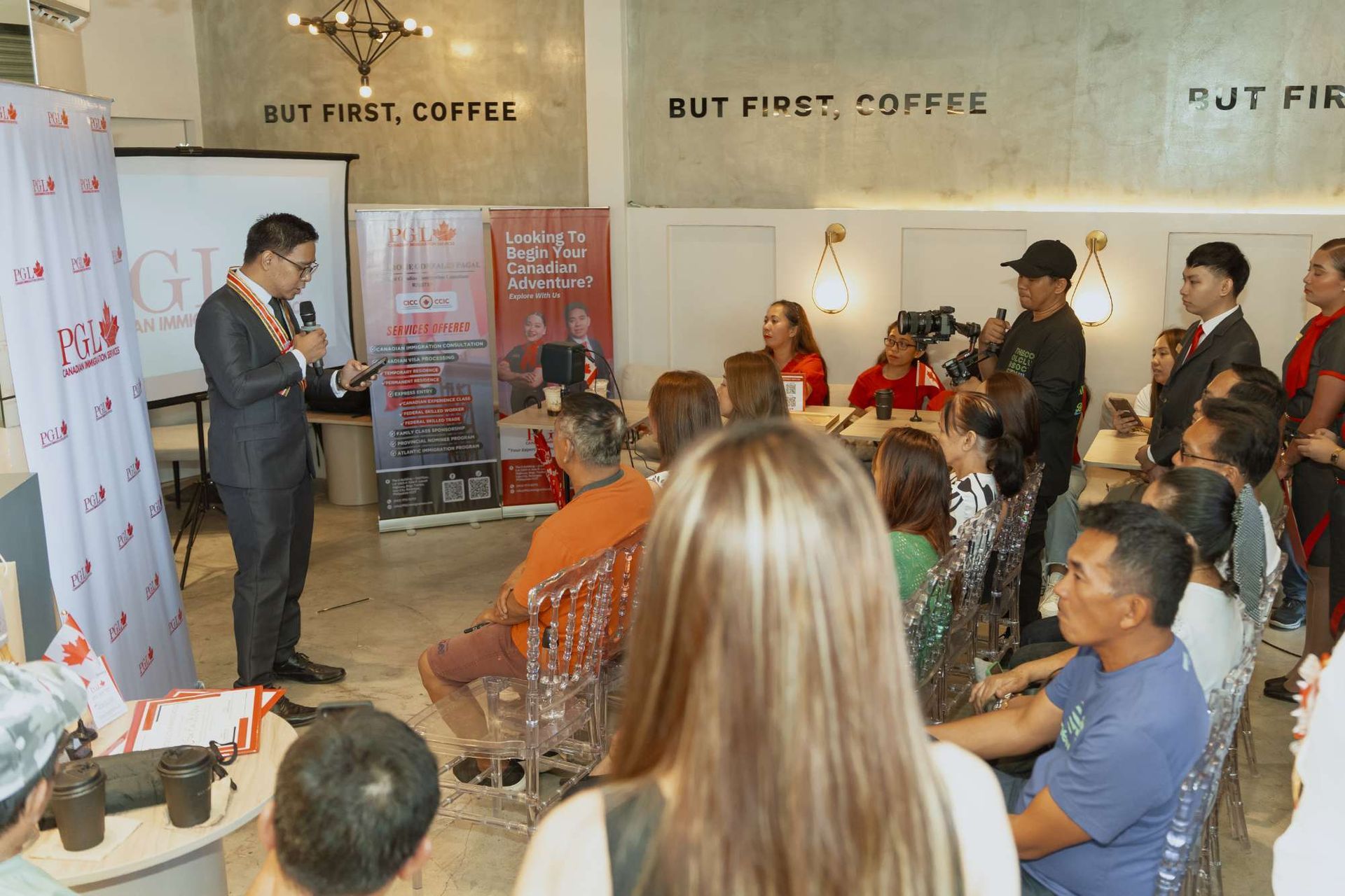 A man is giving a presentation to a group of people in a room.