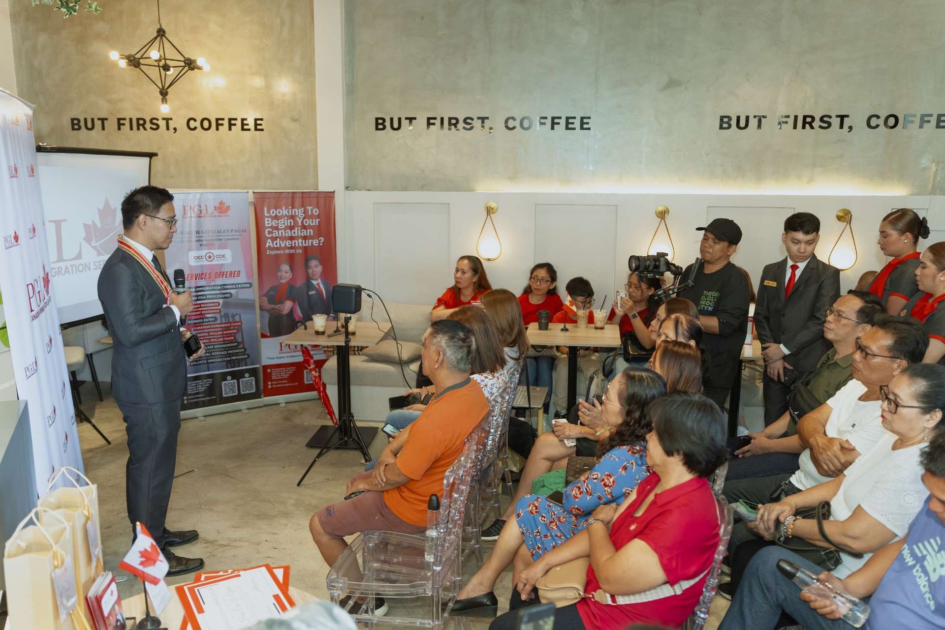 A man is giving a presentation to a group of people sitting in chairs.