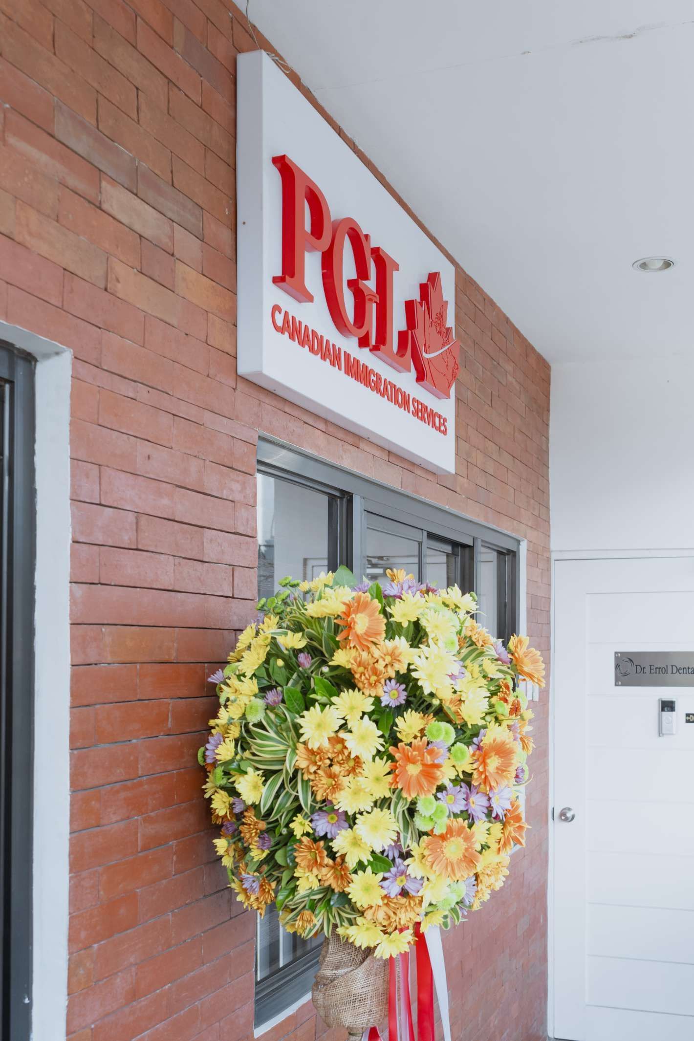 A brick building with a sign that says pgl on it