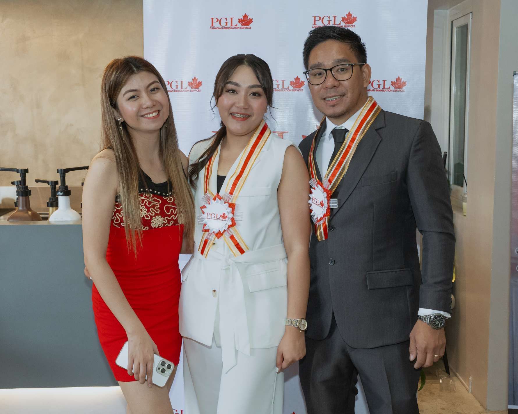 A man in a suit and a woman in a red dress are posing for a picture.
