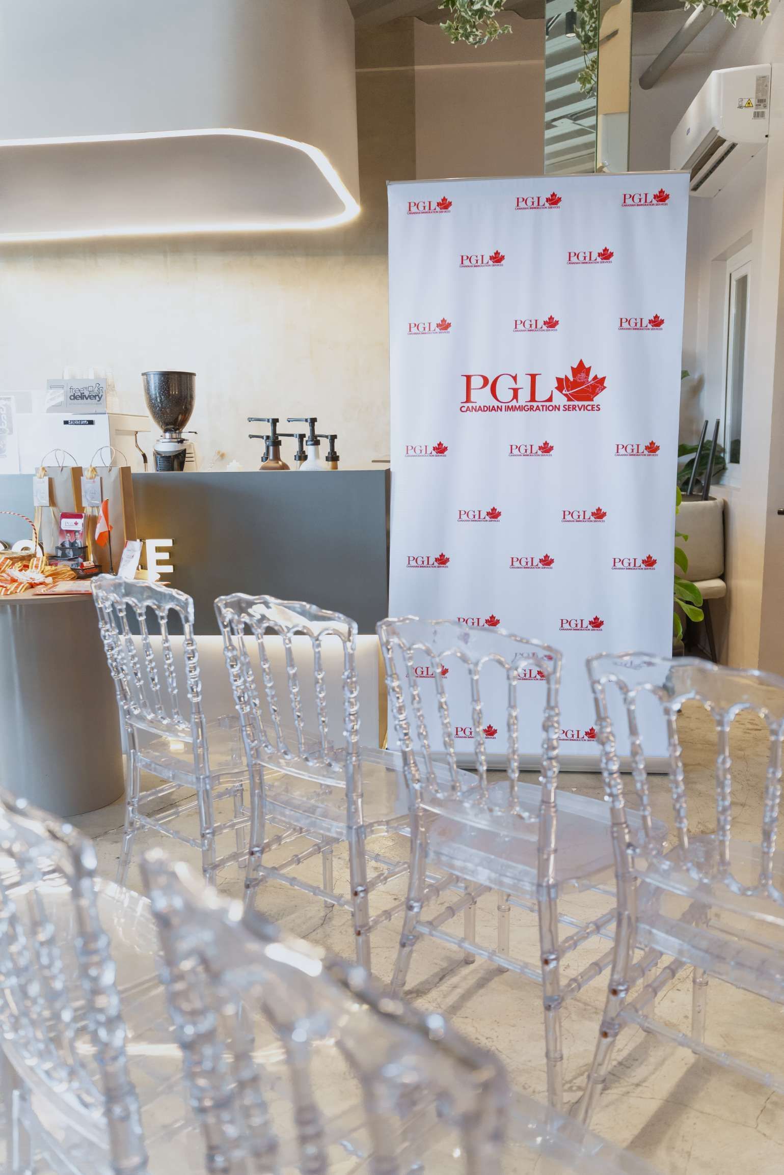 A row of clear plastic chairs are lined up in a room.