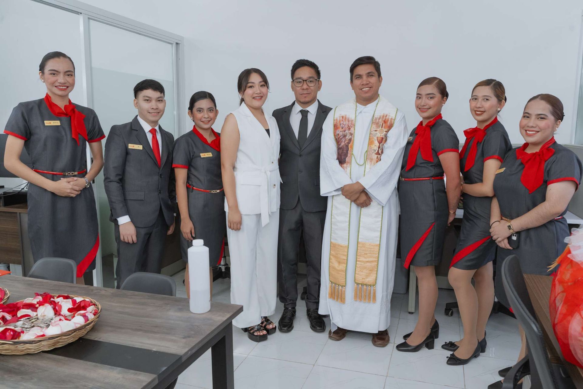 A group of people standing next to each other in a room.