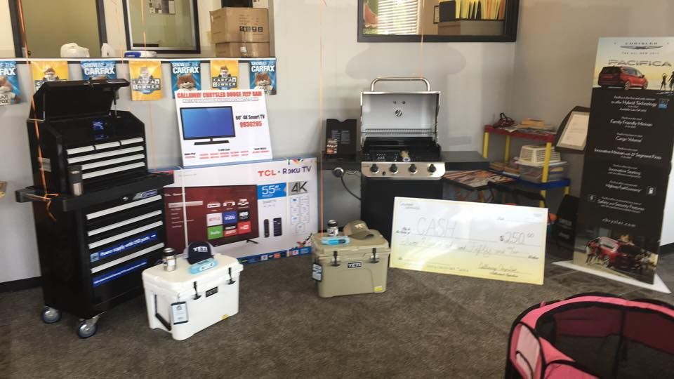 Indoor display of electronics and equipment on tables and shelves in a workshop-like room.