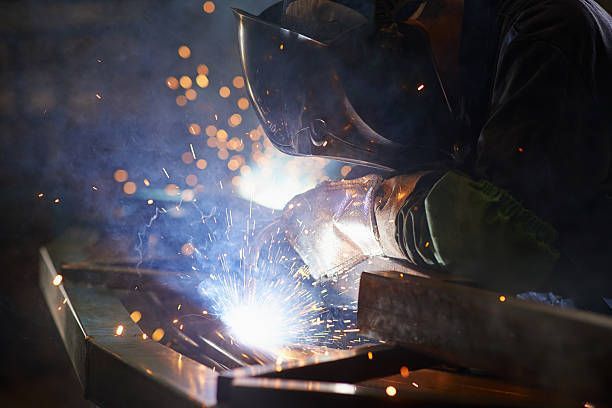 Welder at work with sparks flying