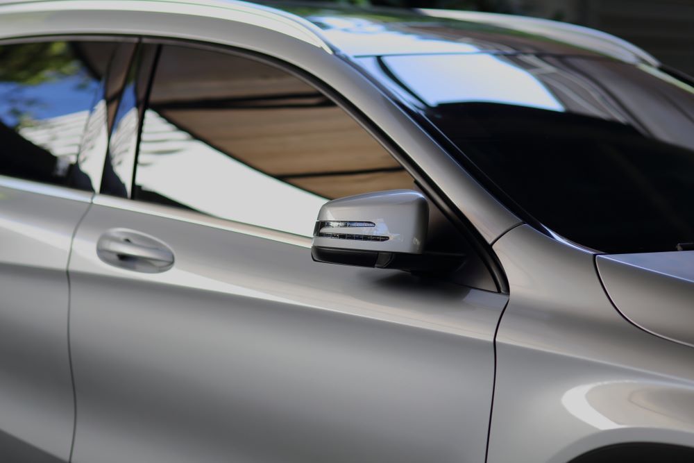 A Silver Car is Parked in a Parking Lot With the Door Open — About Town Windscreen Repairs & Replacements in Wulguru, QLD