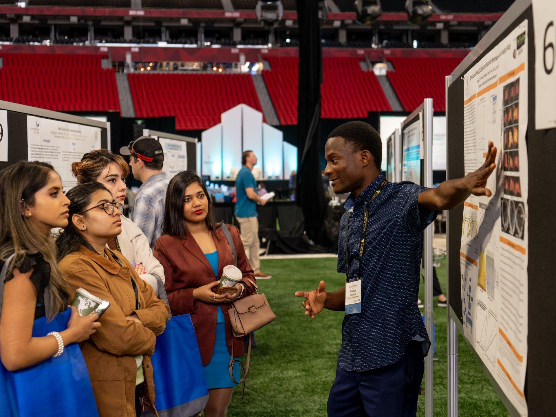 Conference attendees interacting with vendors at an expo