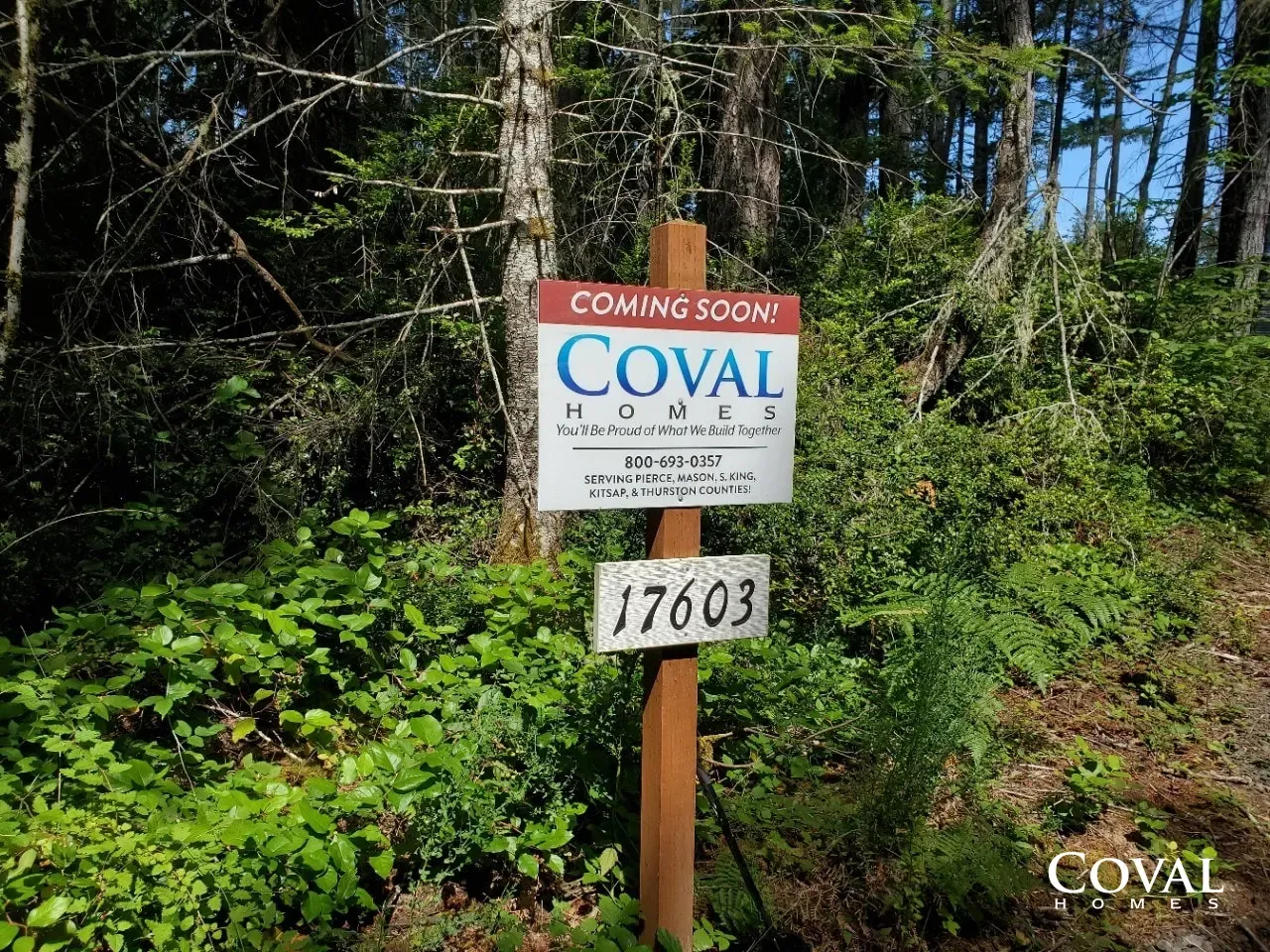 “Coming Soon” sign for Coval beside a wooded path, with address 17603.