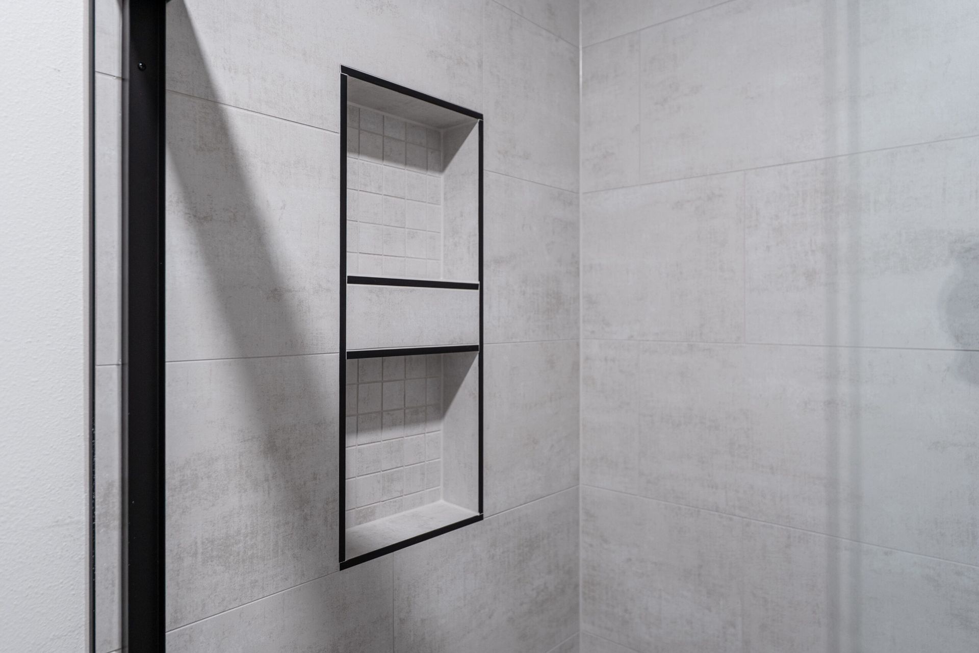 Minimal concrete interior wall with a narrow recessed shelf or niche near a doorway