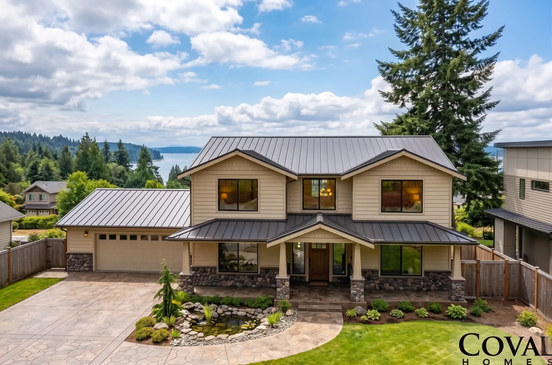 Two-story gray house with attached garage, front porch, and landscaped yard under a blue sky.