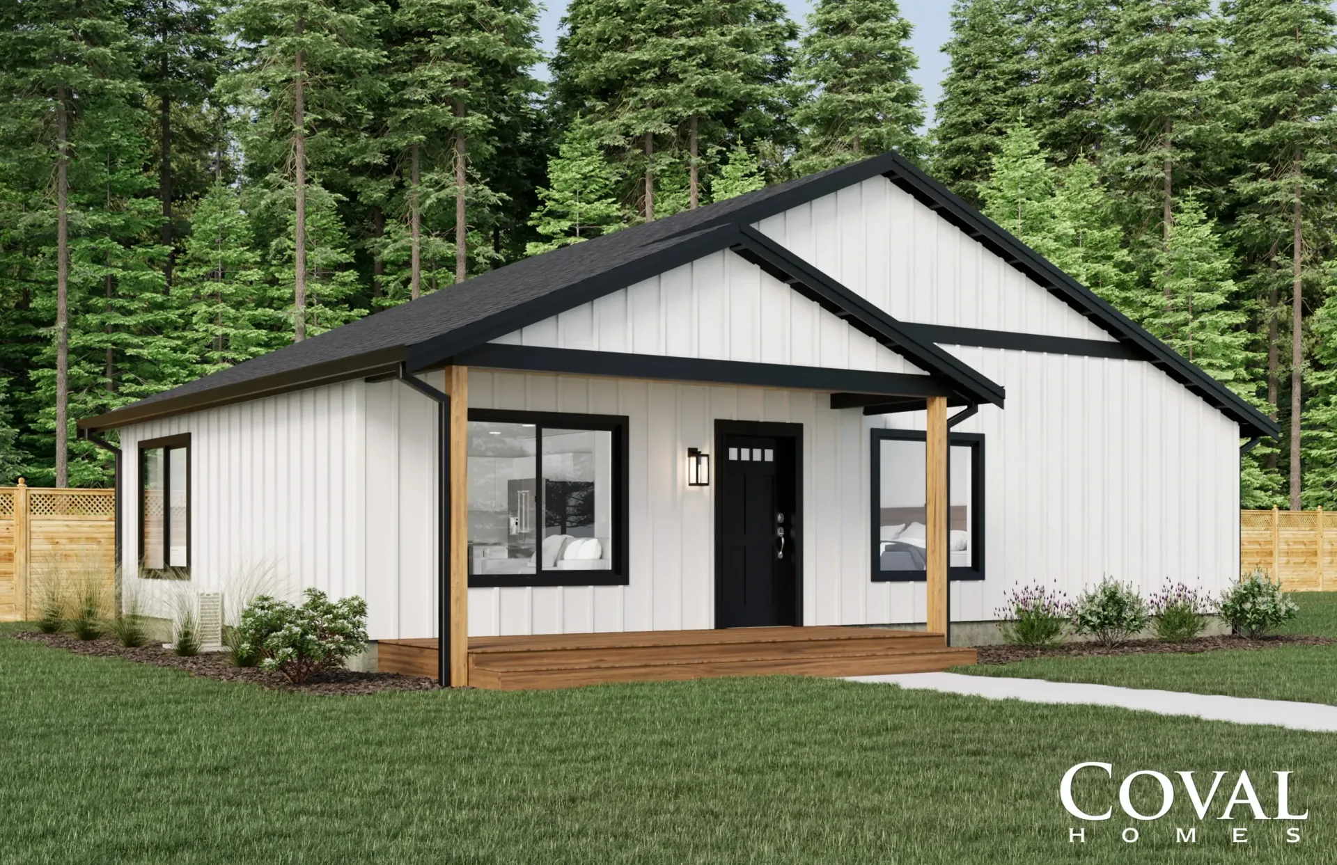 White modern cottage with black roof and porch, set in a grassy yard with tall trees behind.