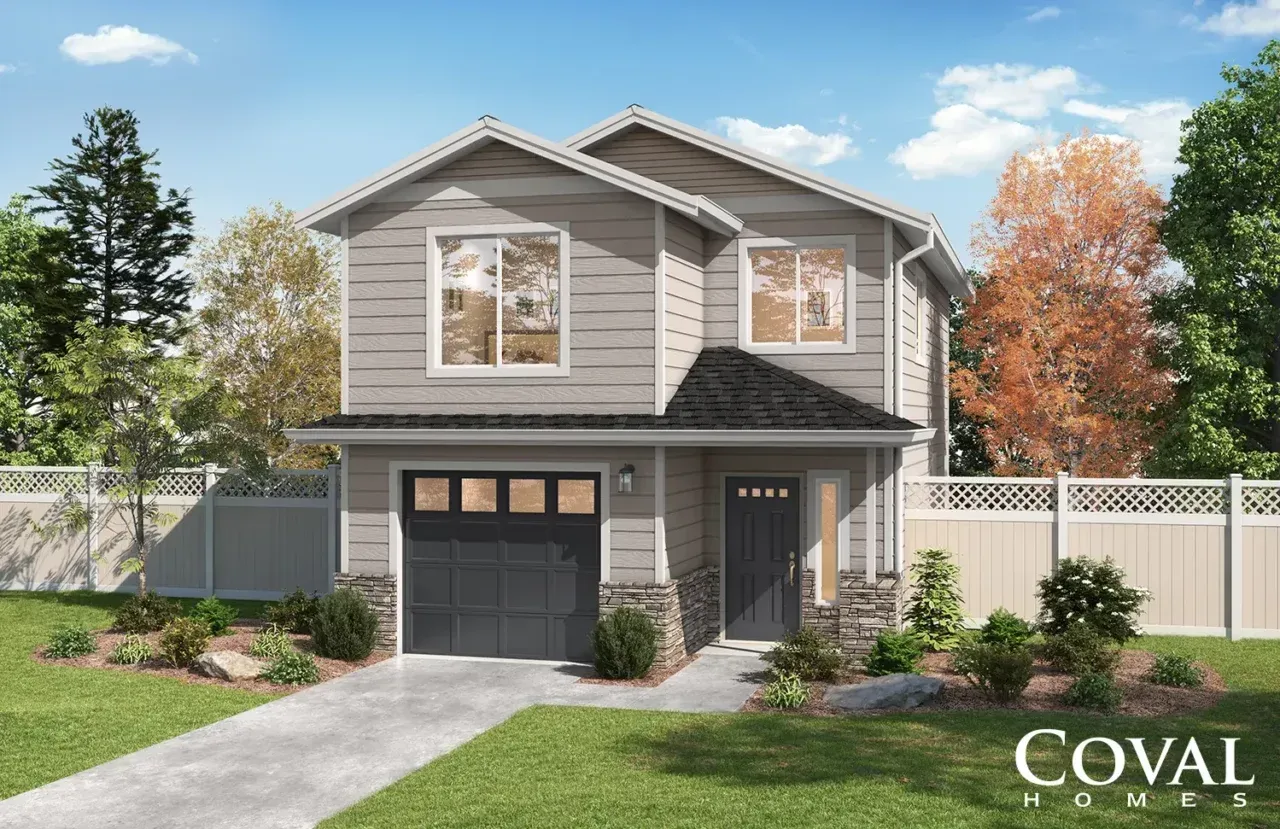 Two-story gray suburban house with black garage door, white fence, and landscaped front yard under a blue sky